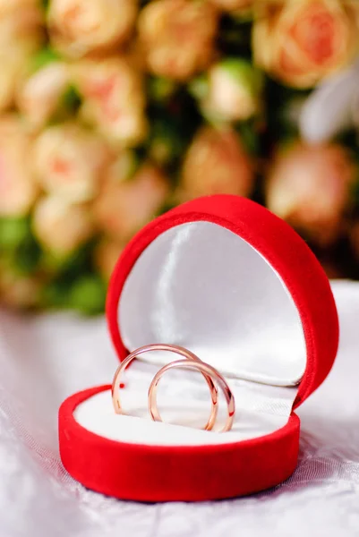 Złote pierścienie i bukiet róż — Zdjęcie stockowe