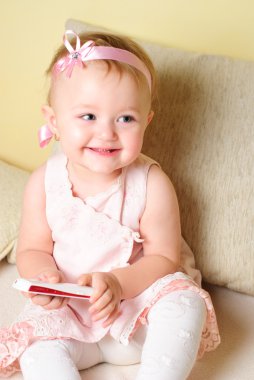 Girl sitting on the sofa clipart