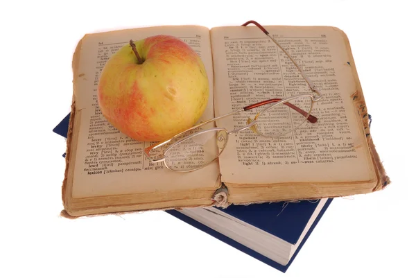 Apple en bril op het boek — Stockfoto