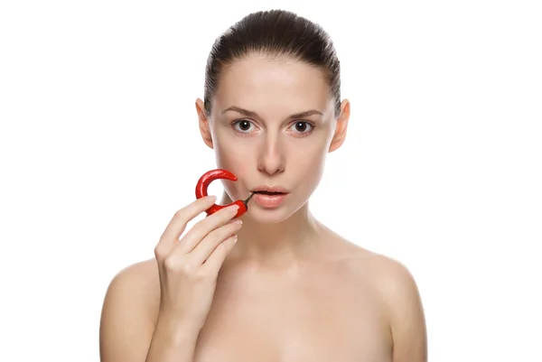 Portrait of young beautiful girl with chili pepper — Stock Photo, Image