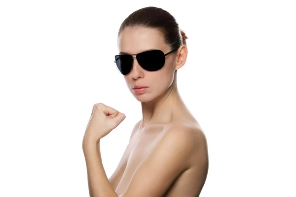 Portrait of woman in sunglasses shows a fist. — Stock Photo, Image