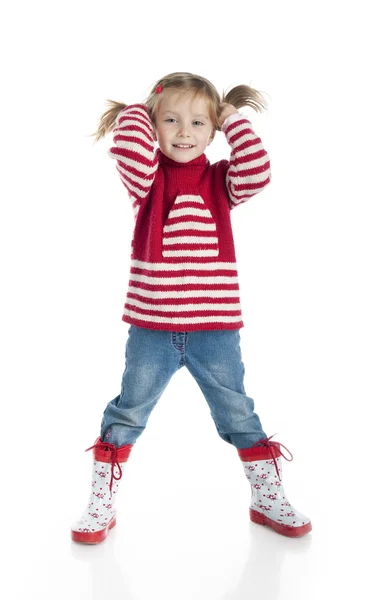 Little girl wearing sweater and gumboots Stock Photo