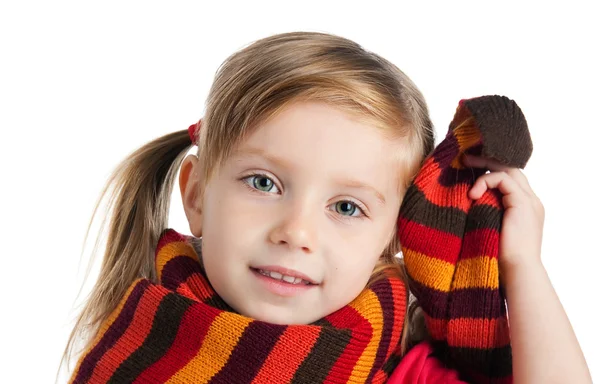 Sad little girl in a striped scarf — Stock Photo, Image