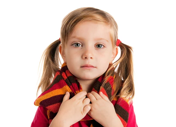 Sad little girl in a striped scarf — Stock Photo, Image