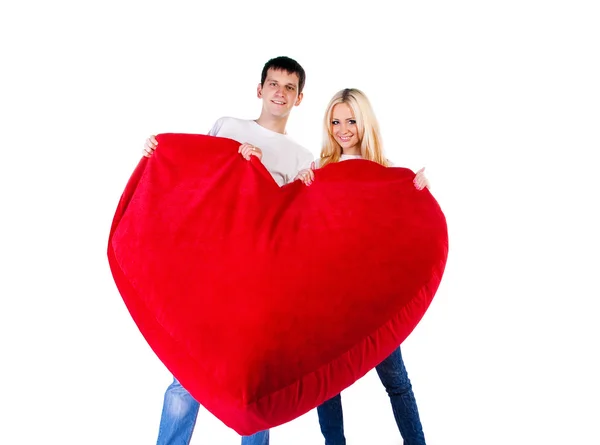 Ungt par med ett stort hjärta på vit — Stockfoto