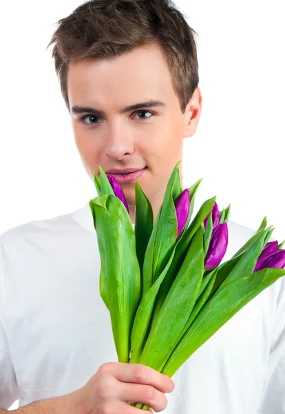 Sevimli genç erkek çiçekleri ver — Stok fotoğraf