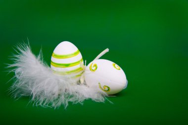 Easter egg in white feathers nest clipart