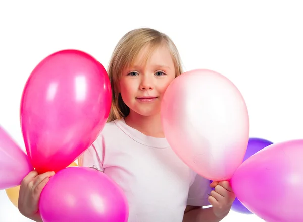 Красивая маленькая девочка с воздушными шарами — стоковое фото