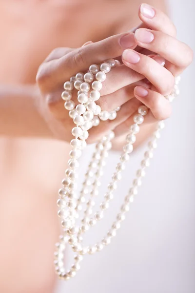 Pearls in the women's hands Royalty Free Stock Photos