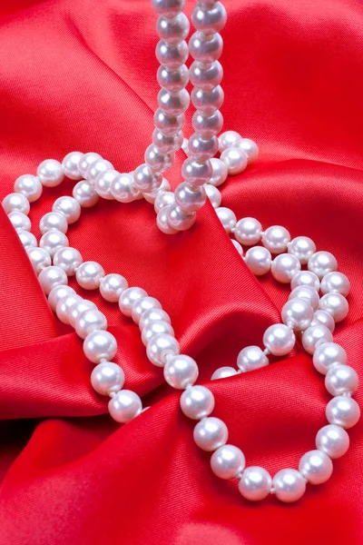 Jewels on white satin — Stock Photo, Image