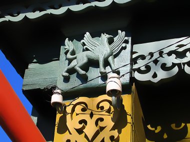 Fragment of a old Russian house with decorative carvings and the figure of a griffin. Shot taken in Kolomna - provincial russian town clipart