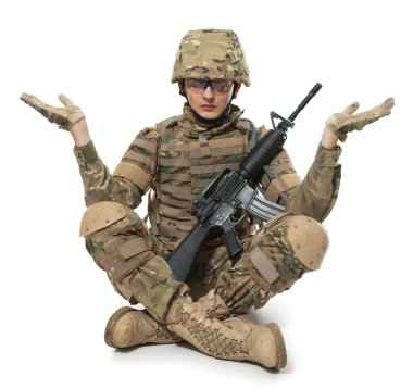 Modern soldier meditating. Isolated on a white background clipart