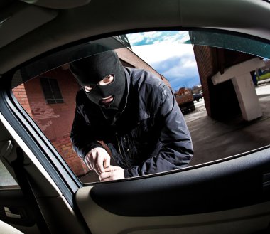 Robber and the thief in a mask hijacks the car clipart