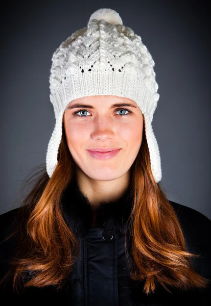Portrait of the young girl in a winter cap on the dark — Stock Photo, Image