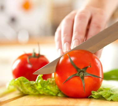 Woman's hands cutting vegetables clipart