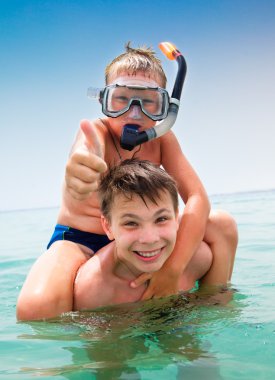 Two boys on a beach clipart