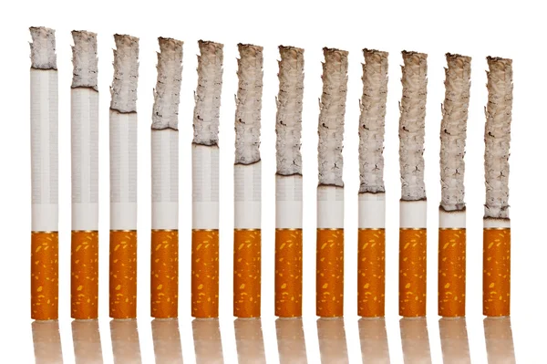 Tända Cigaretter Stå Vit Bakgrund — Stockfoto