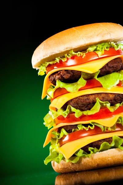 God och aptitlig hamburgare på en mörkt grön — Stockfoto
