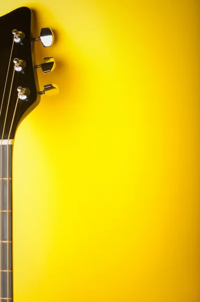 Guitar on a yellow background — Stock Photo, Image