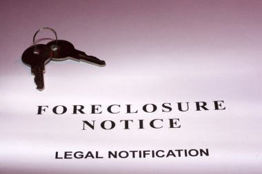 Set of house keys laying on a foreclosure notice. clipart