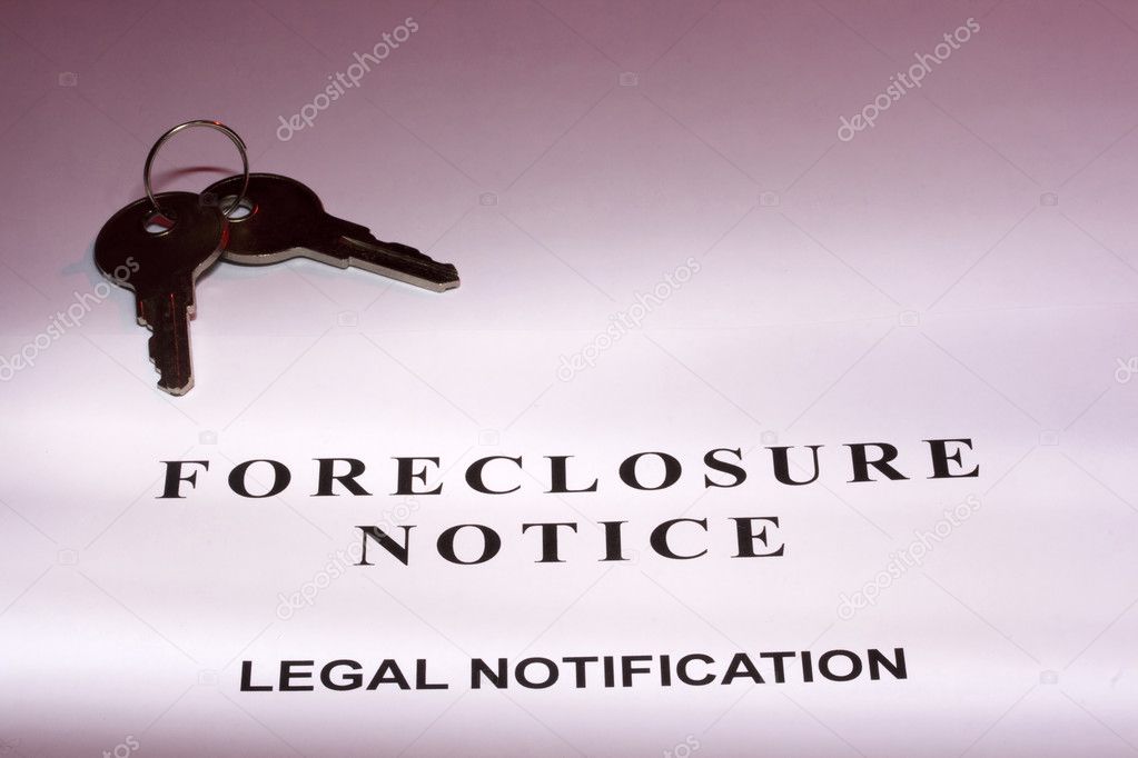 Set of house keys laying on a foreclosure notice.