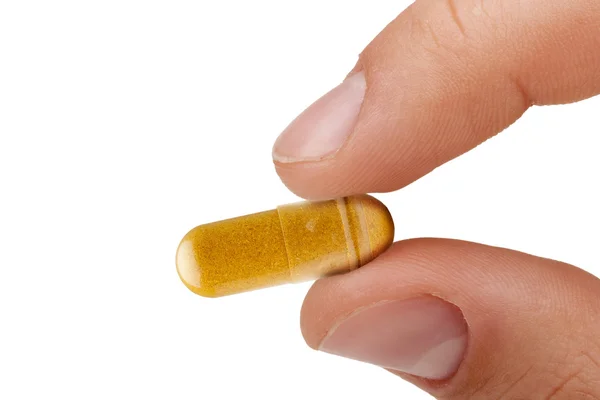 Dedos Segurando Uma Pílula Amarela Contra Doenças Fundo Branco — Fotografia de Stock