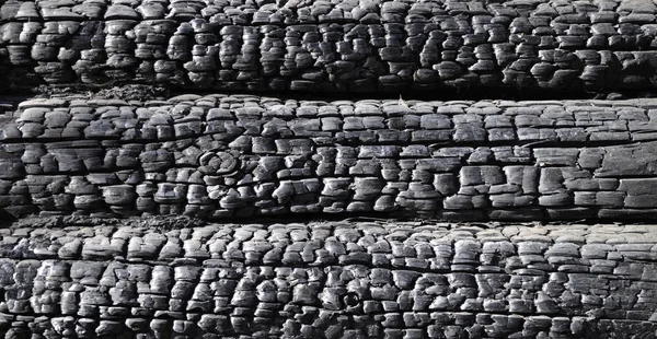 Fragment of burnt log wall — Stock Photo, Image