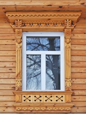 Carving decorated window in new country wooden house, Russia clipart