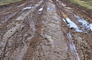 Close up of country dirt road after rain clipart