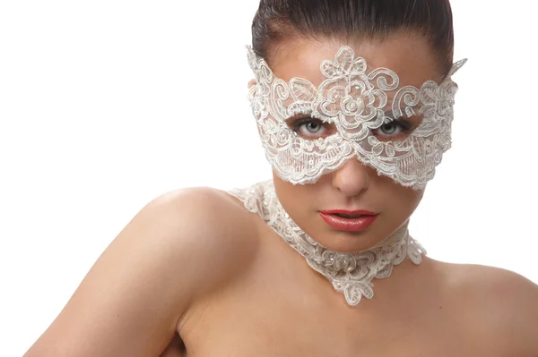 Beautiful woman with tender face in lace mask over her eyes — Stock fotografie