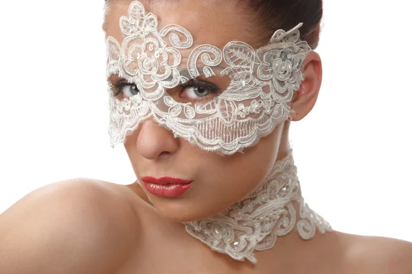 Beautiful woman with tender face in lace mask over her eyes — Stock fotografie