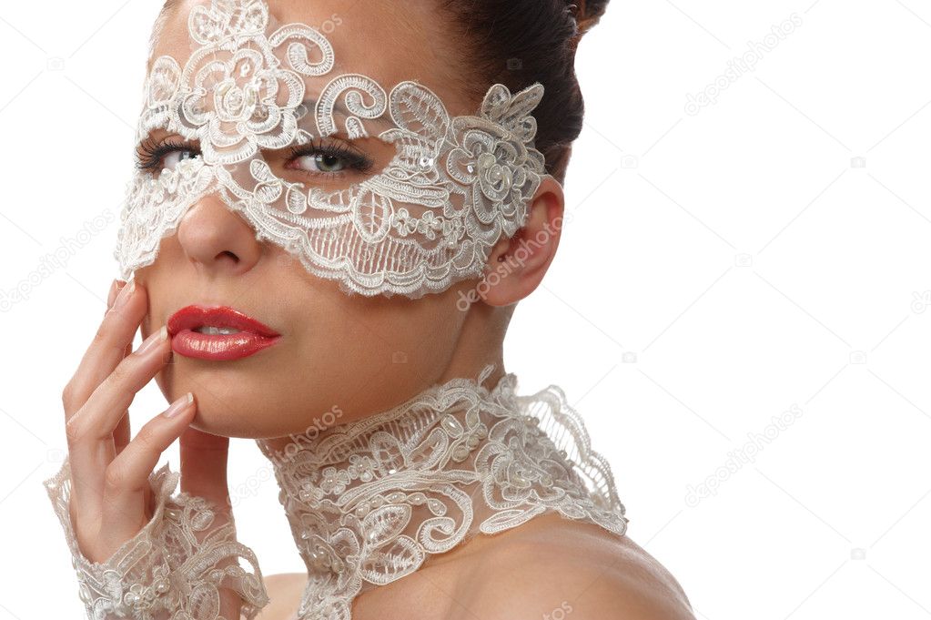 Beautiful woman with tender face in lace mask over her eyes
