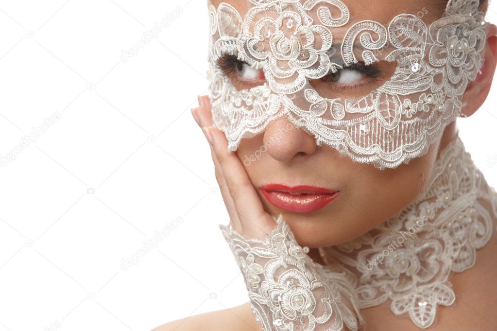 Beautiful woman with tender face in lace mask over her eyes