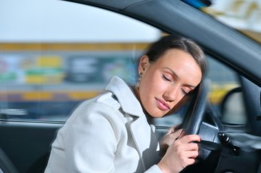 Beautiful woman is sleeping in a car clipart