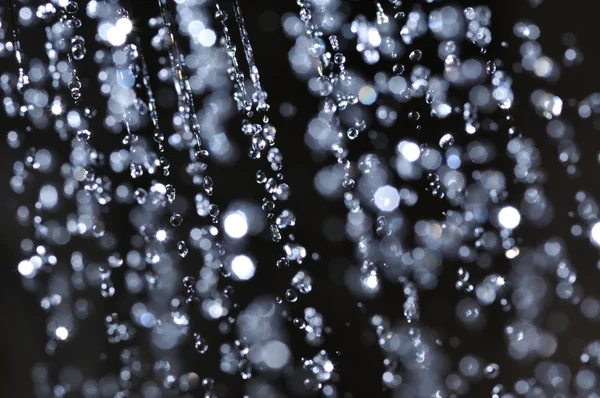 Closeup view of water drops on black background — Stock Photo, Image