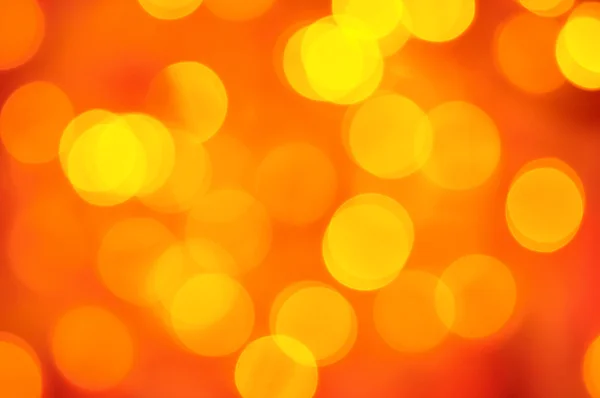 Bulanık altın ışıkları kırmızı zemin üzerine — Stok fotoğraf