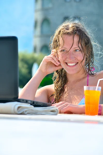 Όμορφη γυναίκα χρησιμοποιώντας το φορητό υπολογιστή στην πισίνα — Φωτογραφία Αρχείου