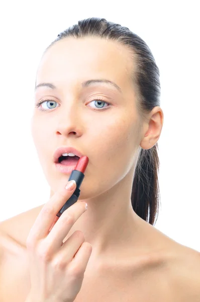 Young attractive sensual woman is applying cosmetics on her face — Stock Photo, Image
