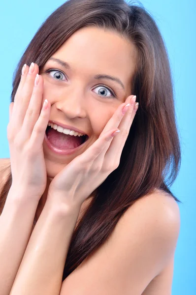 Happy beautiful woman is touching her face and looking at camera — Stock Photo, Image