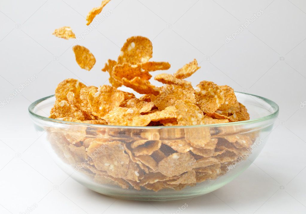 Closeup of a bowl with pouring cereal flakes