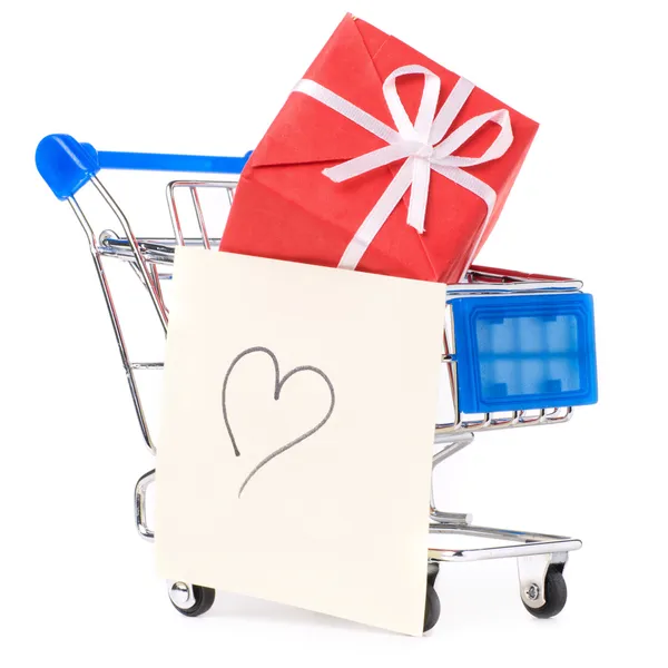 Closeup of a shopping cart with gifts and heart — Stock Photo, Image