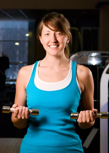 Schöne Frau trainiert abends im Fitnessstudio — Stockfoto