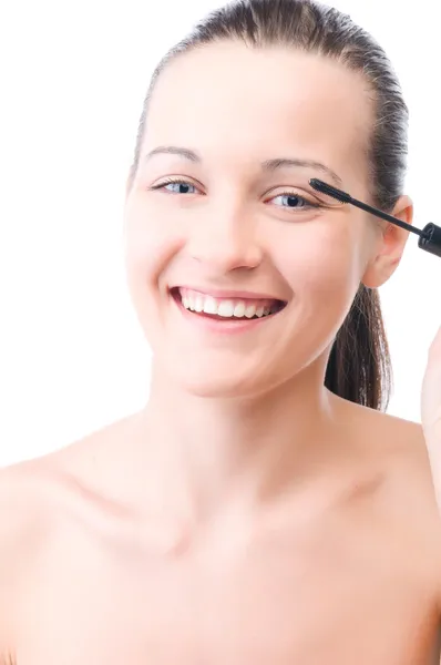 Smiling woman is applying mascara — Stock Photo, Image