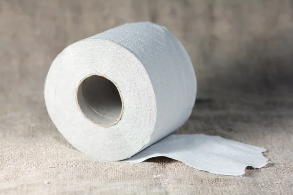 stock image Roll of toilet paper on burlap background