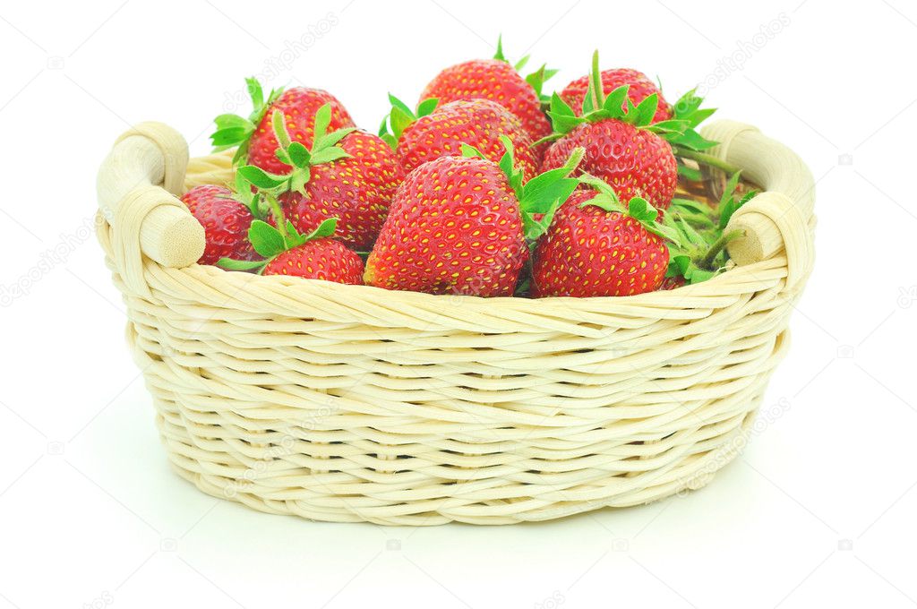 Wooden basket full of fresh strawberries isolated on white background