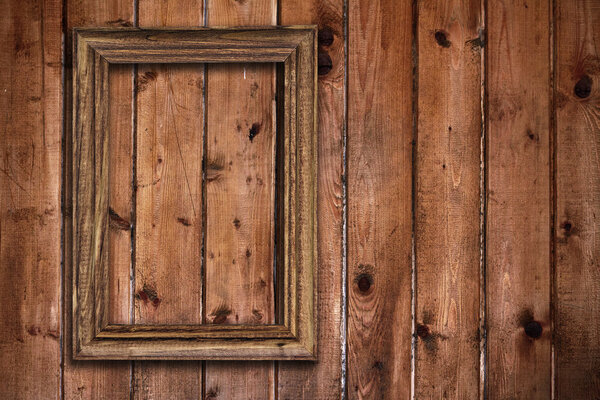 Picture frame on old wooden wall