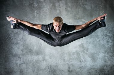 Young man dancer jumping up high clipart