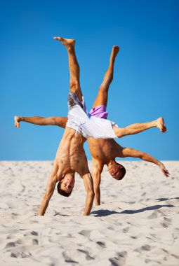 Two sportsmans on beach clipart