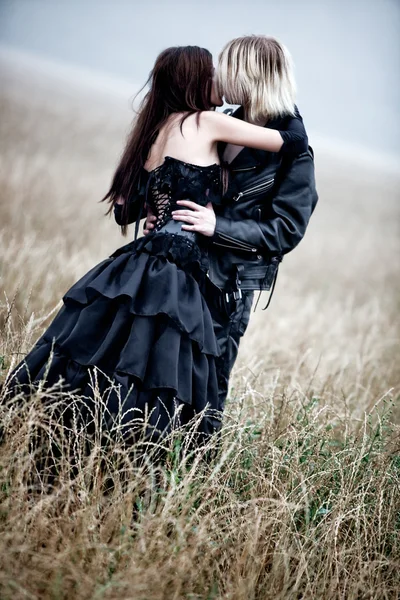 Joven pareja gótica besándose al aire libre — Foto de Stock