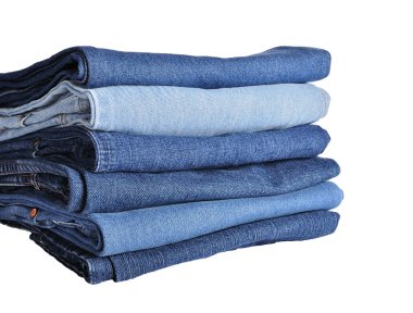 Stack of blue denim jeans isolated on white clipart